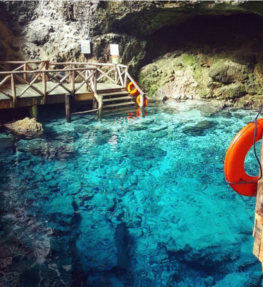 Hoyo Azul cenote in Cap Cana Punta Cana with limestone cliffs and blue water