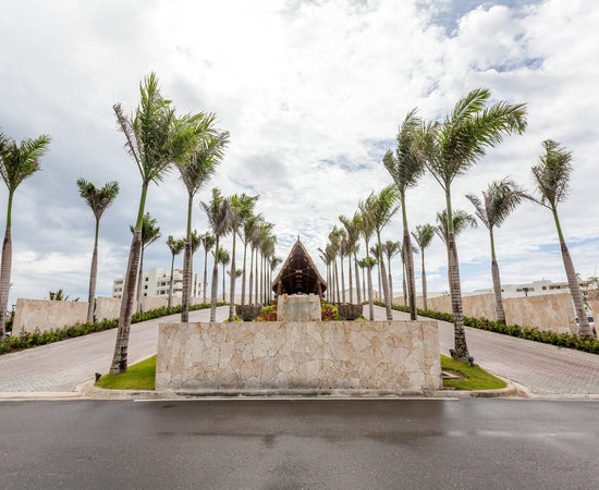 Cap Cana resort entrance with airport transfer vehicle and palm trees